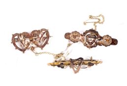 Three Edwardian 9ct rose gold 'sweetheart' brooches.