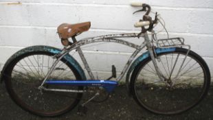 A vintage BSA framed gents bicycle. With Raleigh chain guard, a front rack and bell.
