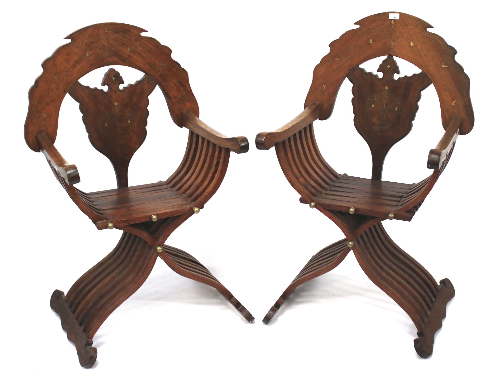 A pair of contemporary mahogany X-framed chairs. With brass inlaid decoration.