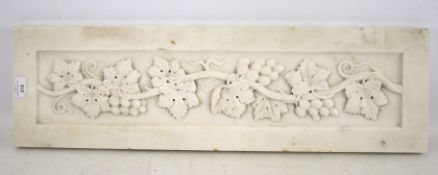 A white marble panel with grape and vine carved decoration. L78cm x D23cm x H3cm.