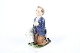 A German Goeble figure of a boy kneeling with a lamb. H15.5cm, marks to the base.