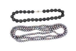 A baroque multi-tone pearl necklace 48" long and black stone necklace with silver clasp.