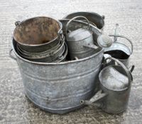 An assortment of galvanized items. Including metal buckets, a watering can, etc.