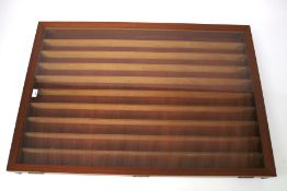 A teak wall mounted model train display cabinet.