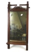 An Edwardian mahogany framed hall mirror. With pierced and carved decoration and small shelf.
