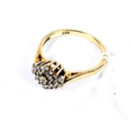 A modern 9ct gold and diamond cluster ring. The 23 round brilliants approx. 0.