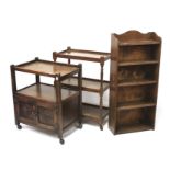 Two oak tea trolleys and a bookcase.