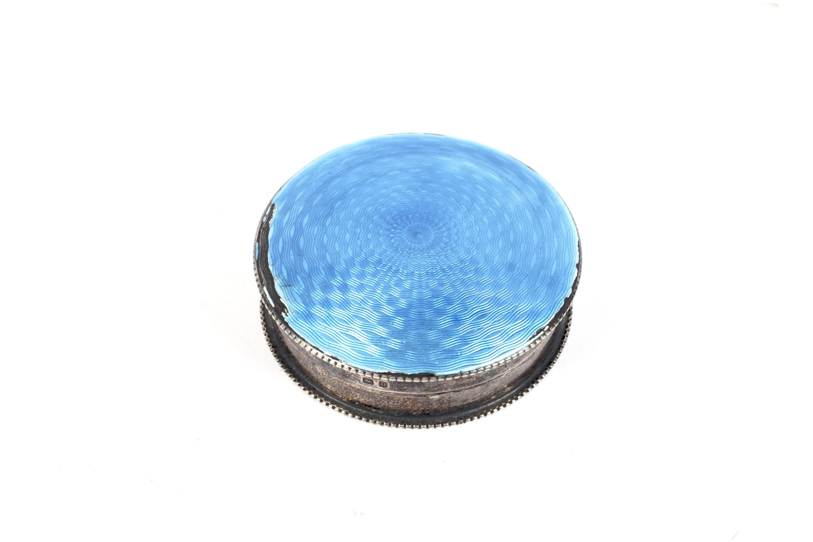 A silver and pale blue guilloche enamelled round box and cover.