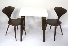 A contemporary table and pair of chairs.