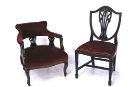 Two red upholstered wooden framed chairs.