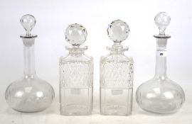Two pairs of 20th century glass decanters and stoppers.