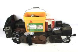 A collection of cameras. Including a Ricoh KR-5, Vivitar, Kodak, etc.