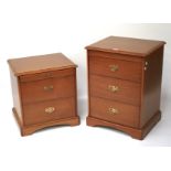 Two Stag bedside cabinets. A two-drawer and three-drawer example with swing handles. Tallest 73cm.