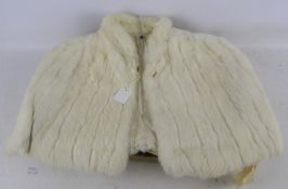 A vintage 1950s/60s small white fur cape. Satin lined approx.