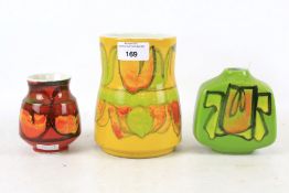 Three Poole Pottery vases. Of assorted shapes with colourful glazes, largest H14.
