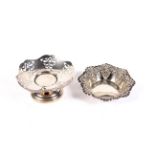 Two decorative silver dishes.