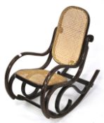 A child's bentwood and cane rocking chair.