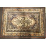 An Abbey Kuba Persian style wool rug. Orange and blue ground geometric design.