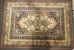 An Abbey Kuba Persian style wool rug. Orange and blue ground geometric design.