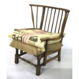 A 20th century oak spindle back framed armchair.