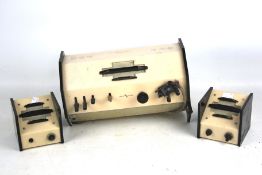 A vintage Bakelite radio and speakers.