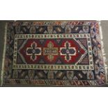 A Persian style rug. Blue and red ground with geometric pattern.