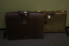 Two vintage leather briefcases and a tin document box.