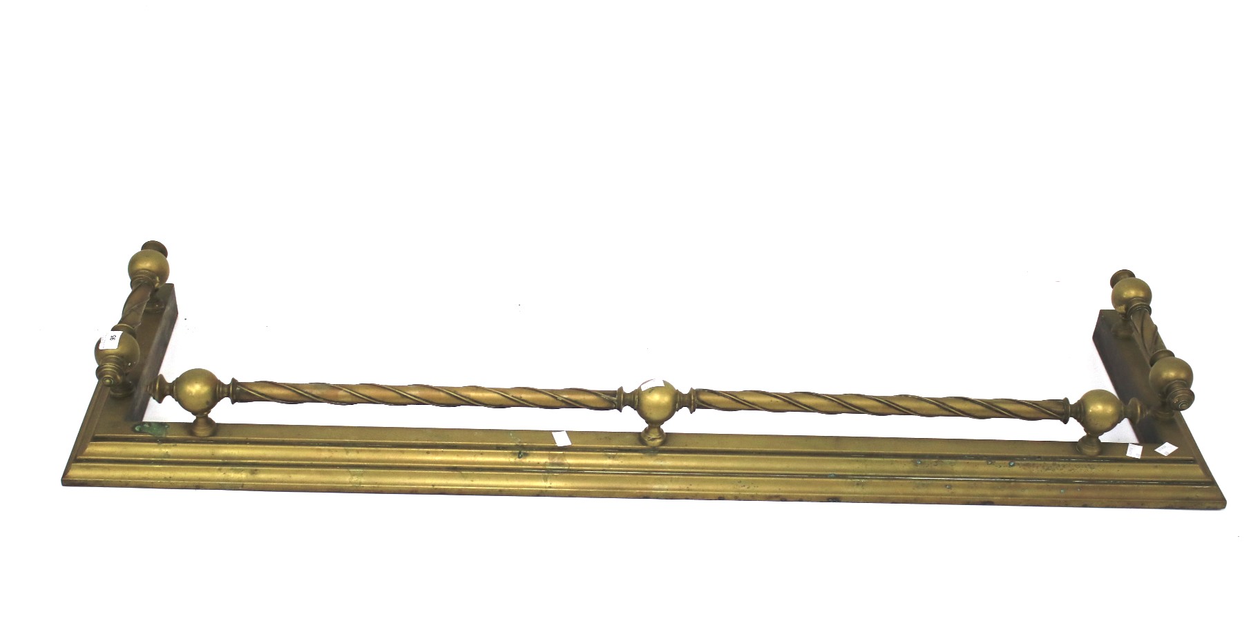 An Edwardian brass fire fender.