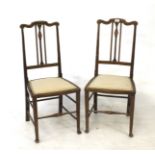 An Edwardian pair of inlaid mahogany bedroom chairs.
