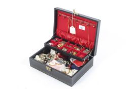 A jewellery box with an assortment of costume jewellery.