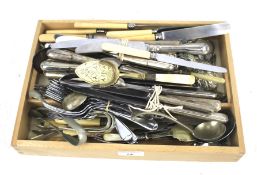 An assortment of vintage flatware. Including silver plate knives, serving spoons, etc.