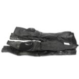 Two pairs of black leather motorcycle trousers.