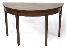 A Georgian mahogany demi-lune table. On square tapering legs.