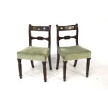 A pair of Victorian mahogany dining room chairs.