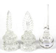 A pair of glass inkwells with feather stoppers and one other. H20.5cm.