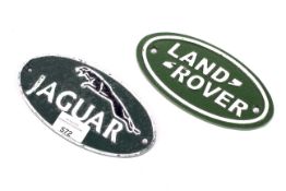 Two reproduction oval cast iron signs. Depicting Land Rover and Jaguar, L17.5cm.