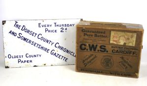 An enamel advertising sign and vintage 'Butter Box'.