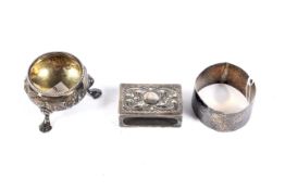 A Victorian silver floral embossed small cauldron-shaped salt, a napkin ring and match box cover.