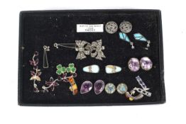 Twelve pairs of assorted silver ladies earrings. Two include amethyst, onyx, and sapphire, etc.