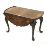 An early 20th century burr walnut drop leaf table.