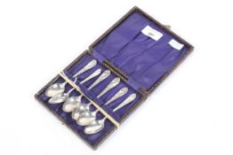 A set of six silver teaspoons with foliate decoration.