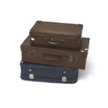 Three vintage suitcases.