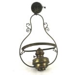 A vintage brass oil lamp converted into a ceiling light. H60cm.