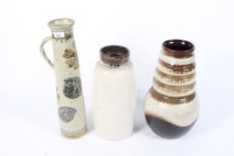 An assortment of three ceramic vases.