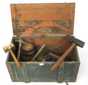A wooden tool box and a collection of vintage hand tools.
