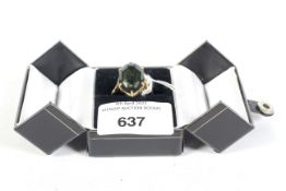 A 9ct gold hallmarked single stone green citrine dress ring mounted in a claw setting. Size T, 7.