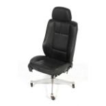 A BMW black leather chair on a Herman Miller swivel base.