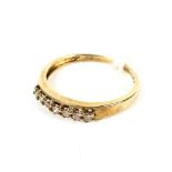 A yellow metal diamond dress ring stamped 375. Set with seven diamonds approx 0.
