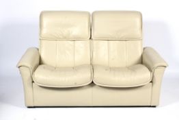 A contemporary cream leatherette upholstered adjustable two-seater sofa. L163cm x D73.