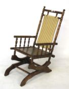 Early 20th century American beech framed rocking chair.